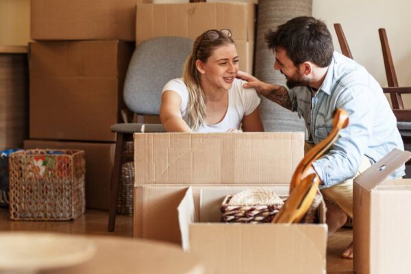 couple working on boxes for moving
